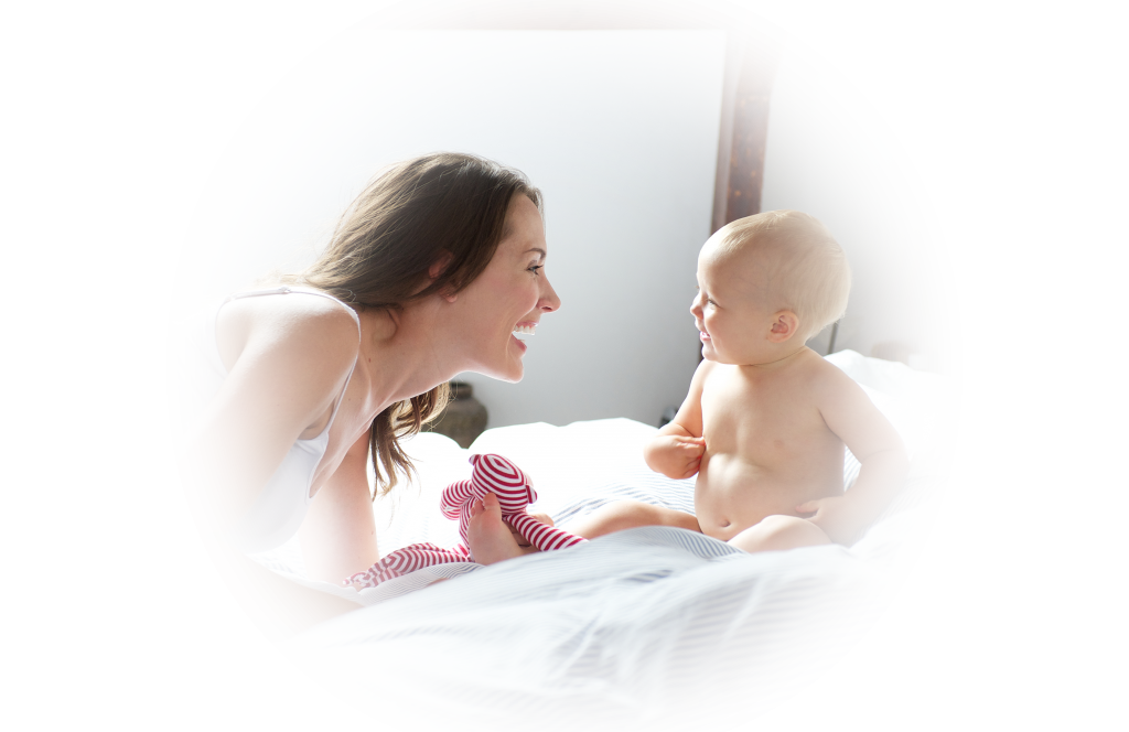 mother-and-baby-playing-on-bed-PVQ7BYS copy
